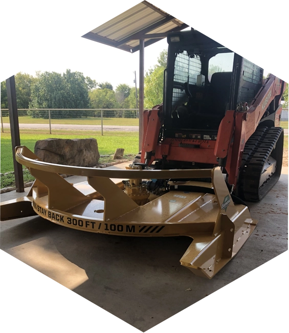 A yellow tractor attachment with safety warning.