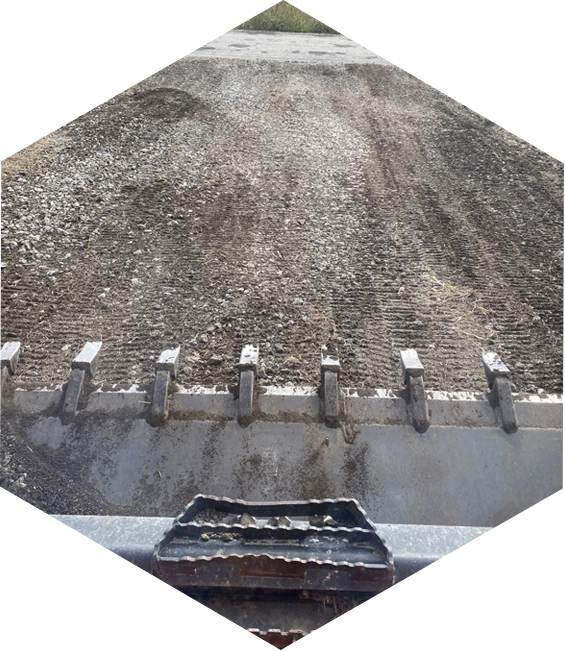 A large pile of dirt on top of a road.